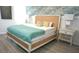 Stylish bedroom featuring a queen-sized bed with a rattan headboard and calming blue accents at 4420 Shiva Loop, Kissimmee, FL 34746