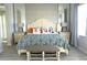 Cozy bedroom with a large bed, decorative pillows, side tables, lamps and patterned wallpaper at 4420 Shiva Loop, Kissimmee, FL 34746