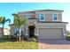 Charming two-story home featuring a red tile roof, two-car garage and well manicured lawn with tropical landscaping at 4420 Shiva Loop, Kissimmee, FL 34746