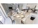 Open-concept kitchen and dining area featuring an island with seating, modern appliances and stylish dining table at 4420 Shiva Loop, Kissimmee, FL 34746