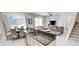 Open-concept kitchen and dining area with granite countertops, stainless steel appliances, and dining table with seating at 4420 Shiva Loop, Kissimmee, FL 34746