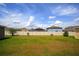 Open backyard view showcasing a well-maintained lawn and privacy fence at 4423 Blackbird St, Kissimmee, FL 34746