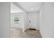 Bright entryway featuring neutral-toned tile flooring, a solid white door, and a window at 4423 Blackbird St, Kissimmee, FL 34746