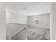 Bright hallway featuring neutral paint, plush carpeting, and plenty of natural light at 4423 Blackbird St, Kissimmee, FL 34746