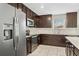 Modern kitchen featuring stainless steel appliances, dark wood cabinets, and a white tile backsplash at 4423 Blackbird St, Kissimmee, FL 34746