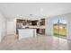 Open kitchen featuring dark wood cabinets, stainless appliances, white tile backsplash, and white countertop island at 4423 Blackbird St, Kissimmee, FL 34746