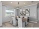 A dining room features a wooden table with white chairs, modern lighting, and abstract wall art at 4619 Flagstaff Ct, Orlando, FL 32820