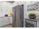 Contemporary kitchen with stainless steel refrigerator and a built-in wine cooler at 4619 Flagstaff Ct, Orlando, FL 32820