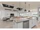 A modern kitchen with stainless steel appliances overlooks a living room with a decorative ceiling at 4619 Flagstaff Ct, Orlando, FL 32820