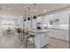 Modern kitchen featuring white cabinets, island with seating, and open dining area at 4619 Flagstaff Ct, Orlando, FL 32820