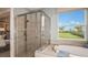 This bathroom features a glass shower, soaking tub, and expansive views out the window at 5235 Bowspirit Way, St Cloud, FL 34771