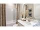 Bathroom features a bathtub, shower, decorative mirror, towels, and toiletries at 5235 Bowspirit Way, St Cloud, FL 34771