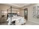 This main bedroom boasts a four-poster bed, carpet, and an adjacent doorway to the bathroom at 5235 Bowspirit Way, St Cloud, FL 34771