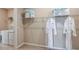 This walk-in closet includes shelving, hanging clothes, and laundry facilities at 5235 Bowspirit Way, St Cloud, FL 34771