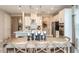 Modern kitchen and dining area with white cabinets, stainless steel appliances, pendant lights and a wooden table at 5235 Bowspirit Way, St Cloud, FL 34771