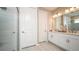 Bright bathroom featuring white cabinets, a double sink, and a glass-enclosed shower with modern fixtures at 5241 Quillback Ln, St Cloud, FL 34771
