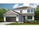Charming two-story home showcases neutral paint, green shutters, manicured lawn, and inviting two-car garage at 5241 Quillback Ln, St Cloud, FL 34771