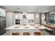 A modern kitchen shines with white cabinets, stainless appliances, a stylish island, and elegant pendant lighting at 5241 Quillback Ln, St Cloud, FL 34771