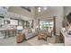A spacious living room boasts an open floor plan, ample seating, an open kitchen, and stylish decor at 5241 Quillback Ln, St Cloud, FL 34771