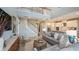 A spacious living room boasts a soaring ceiling, ample seating, an open staircase, and stylish decor at 5241 Quillback Ln, St Cloud, FL 34771