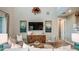 A spacious living room boasts a soaring ceiling, ample seating, a stylish TV, and modern decor at 5241 Quillback Ln, St Cloud, FL 34771