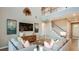 A spacious living room boasts a soaring ceiling, ample seating, an open staircase, and stylish decor at 5241 Quillback Ln, St Cloud, FL 34771