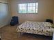 Simple bedroom with wood floors, a large window, and a closet for ample storage at 5505 Hernandes Dr # 118, Orlando, FL 32808