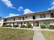 Exterior view of a multi-Gathering complex with well-maintained landscaping and a bright blue sky at 5505 Hernandes Dr # 118, Orlando, FL 32808
