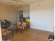 Bright living room with wood floors, cozy seating, and adjacent access to the kitchen at 5505 Hernandes Dr # 118, Orlando, FL 32808