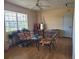 Another shot of the light and airy living room, complete with wood floors and comfortable chairs at 5505 Hernandes Dr # 118, Orlando, FL 32808