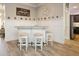 Stylish custom bar area with wood-look tile flooring and elegant decor at 5896 Barclay Ct, The Villages, FL 32163