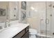Modern bathroom featuring a glass shower, single sink vanity and coastal decor at 5896 Barclay Ct, The Villages, FL 32163
