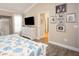Bright bedroom features a TV, hardwood floors, and pictures on the wall at 5896 Barclay Ct, The Villages, FL 32163