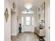 Inviting entryway with chandelier, front door, and stylish decor and beautiful tiled floors at 5896 Barclay Ct, The Villages, FL 32163