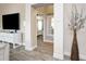 An inviting interior hallway with bright colors, artwork, and wood-look tile flooring at 5896 Barclay Ct, The Villages, FL 32163