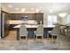 Beautiful kitchen with large center island, bar seating, and pendant lighting with stainless steel appliances at 5896 Barclay Ct, The Villages, FL 32163