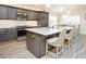 Kitchen island featuring granite countertops, pendant lighting and bar stool seating at 5896 Barclay Ct, The Villages, FL 32163