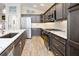 Well-appointed kitchen featuring stainless steel appliances, dark wood cabinets and white countertops at 5896 Barclay Ct, The Villages, FL 32163