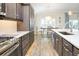 A modern kitchen with granite countertops, stainless steel appliances, and a breakfast nook at 5896 Barclay Ct, The Villages, FL 32163