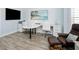 Spacious home office area with desk, coastal decor and wood look floors at 5896 Barclay Ct, The Villages, FL 32163