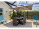 Covered patio with dining table, chairs and an outdoor umbrella at 5896 Barclay Ct, The Villages, FL 32163