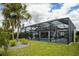 Enclosed pool area with mature landscaping and a large lanai, perfect for outdoor relaxation at 5896 Barclay Ct, The Villages, FL 32163