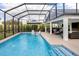 A sparkling pool with water features and sun loungers, situated near a covered outdoor living area at 5896 Barclay Ct, The Villages, FL 32163