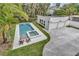 Aerial view of a pool and lush backyard of a two-story white house and garage at 613 Daniels Ave, Orlando, FL 32801