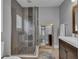 This bathroom features a glass shower and large mirror that reflects into another room at 613 Daniels Ave, Orlando, FL 32801