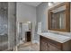 Stylish bathroom featuring a glass shower, large mirror, and vanity with plenty of natural light at 613 Daniels Ave, Orlando, FL 32801