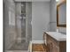 Bathroom featuring a glass enclosed shower, wood floors, custom vanity and neutral gray paint at 613 Daniels Ave, Orlando, FL 32801