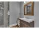 Bathroom featuring a glass enclosed shower, wood floors, custom vanity and neutral gray paint at 613 Daniels Ave, Orlando, FL 32801