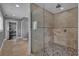 Well-lit bathroom featuring a large glass shower with stone-style tiling and flooring at 613 Daniels Ave, Orlando, FL 32801