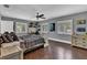 Spacious bedroom with a ceiling fan, windows with shutters, and a desk at 613 Daniels Ave, Orlando, FL 32801